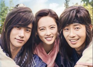 Historical drama trio smiling.