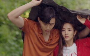 Couple sharing jacket in rain.
