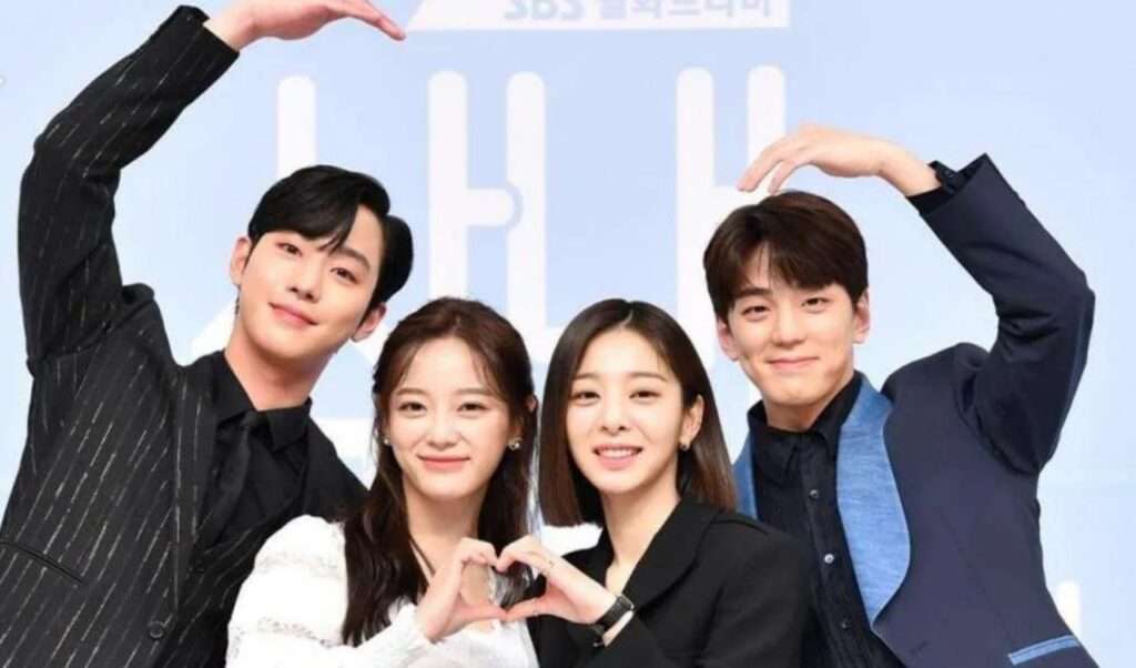 K-drama cast making heart signs.