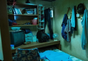 Cramped room with hanging clothes. 