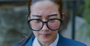 Woman with acne wearing glasses
