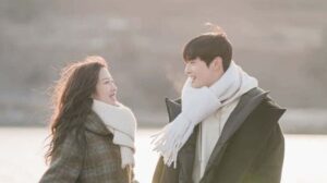 Smiling couple in winter coats.
