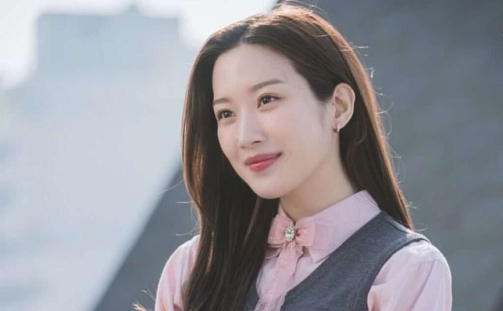 Woman smiling in formal attire.