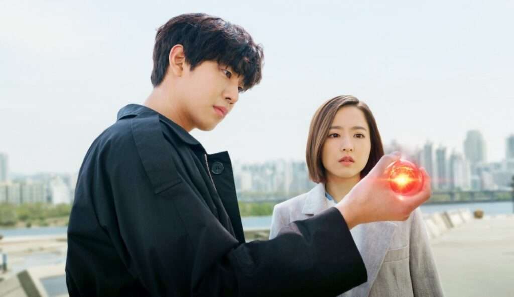 Man holding glowing red orb. 