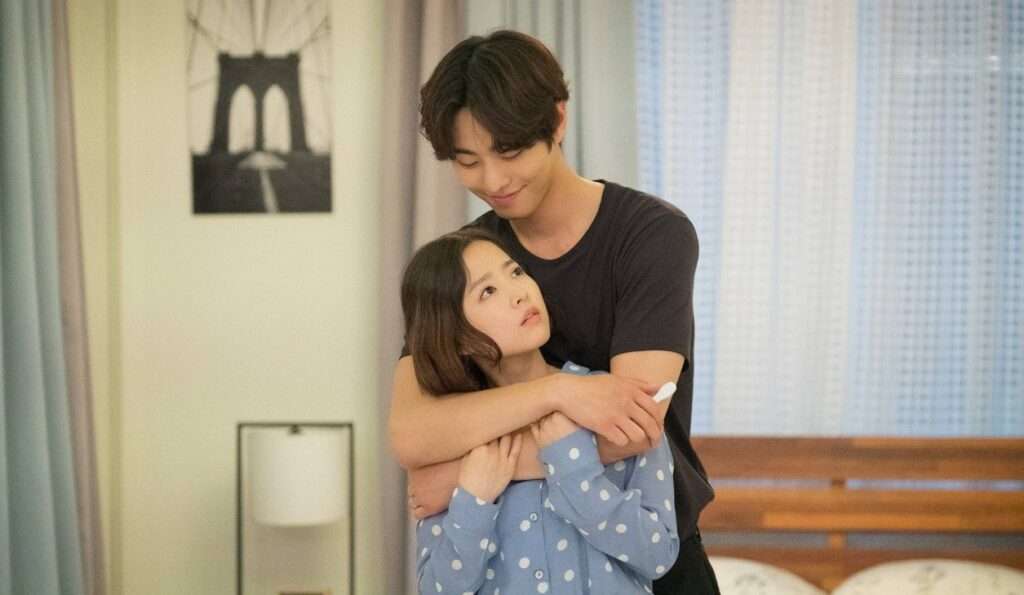 Hooded figure with glowing crystal. 