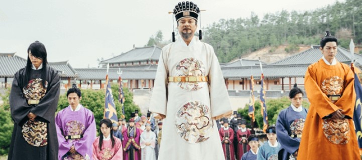 Moon Lovers: Scarlet Heart Ryeo royal scene featuring the king in traditional Korean attire, surrounded by his sons and court officials in vibrant royal robes, highlighting the power dynamics and tension in the drama