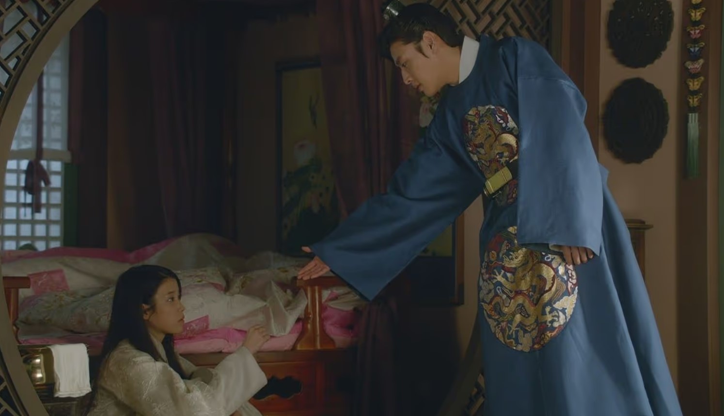 Moon Lovers: Scarlet Heart Ryeo emotional moment between Kang Ha-Neul and IU, with Kang Ha-Neul extending his hand to IU, both in traditional royal attire, set in a warm and intimate room