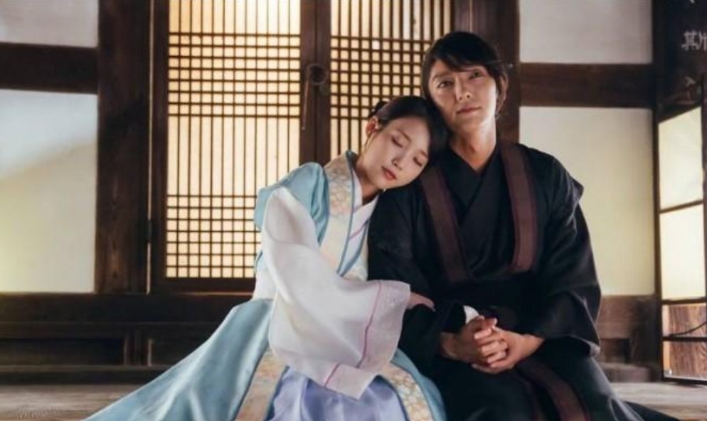 Moon Lovers: Scarlet Heart Ryeo tender moment between IU and Lee Joon-Gi, with IU resting her head on Lee Joon-Gi's shoulder in a traditional setting, conveying a sense of peace, trust, and emotional closeness