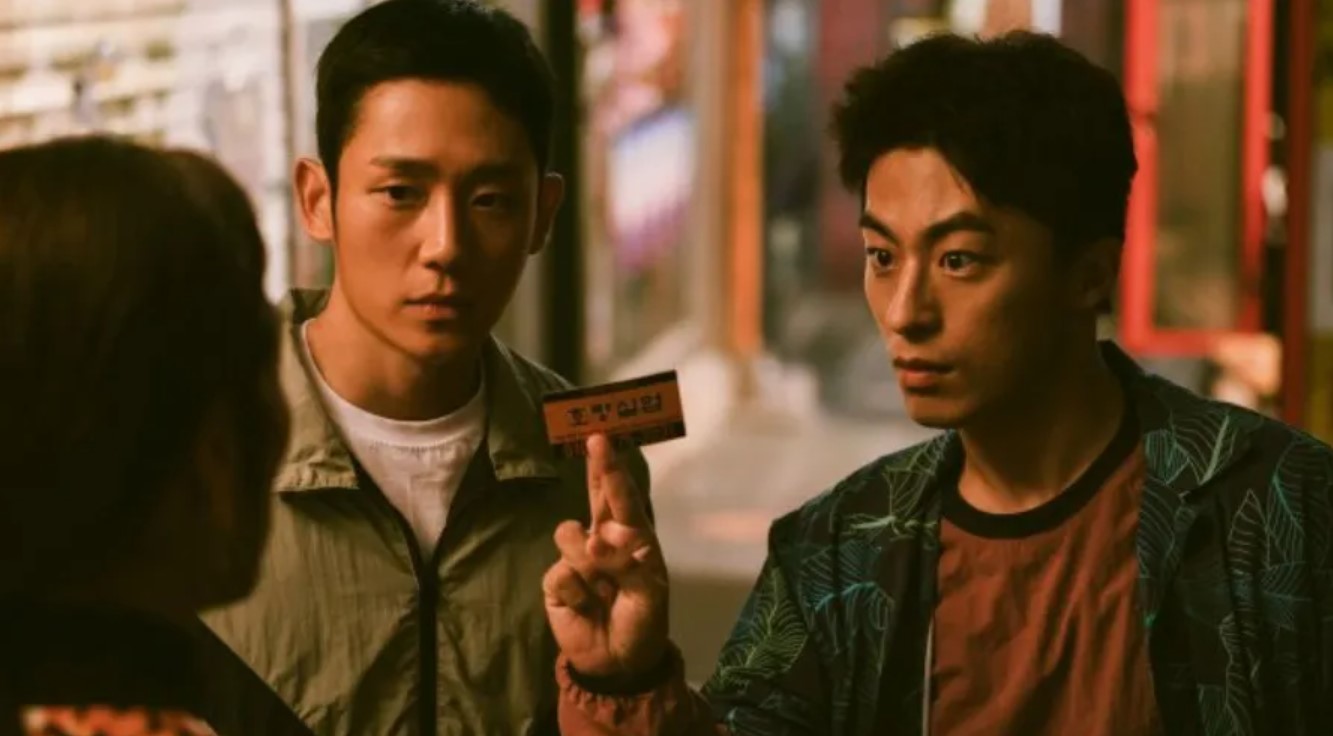 Scene from D.P. Season 2 showing An Jun-ho and Han Ho-yeol confronting a civilian with a missing person notice 