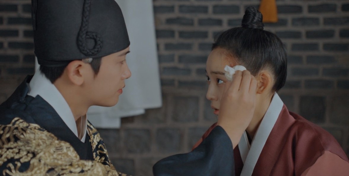A tender moment between the lead characters of Our Blooming Youth, as the male protagonist gently tends to the female lead's injury. Perfect for an Our Blooming Youth full review