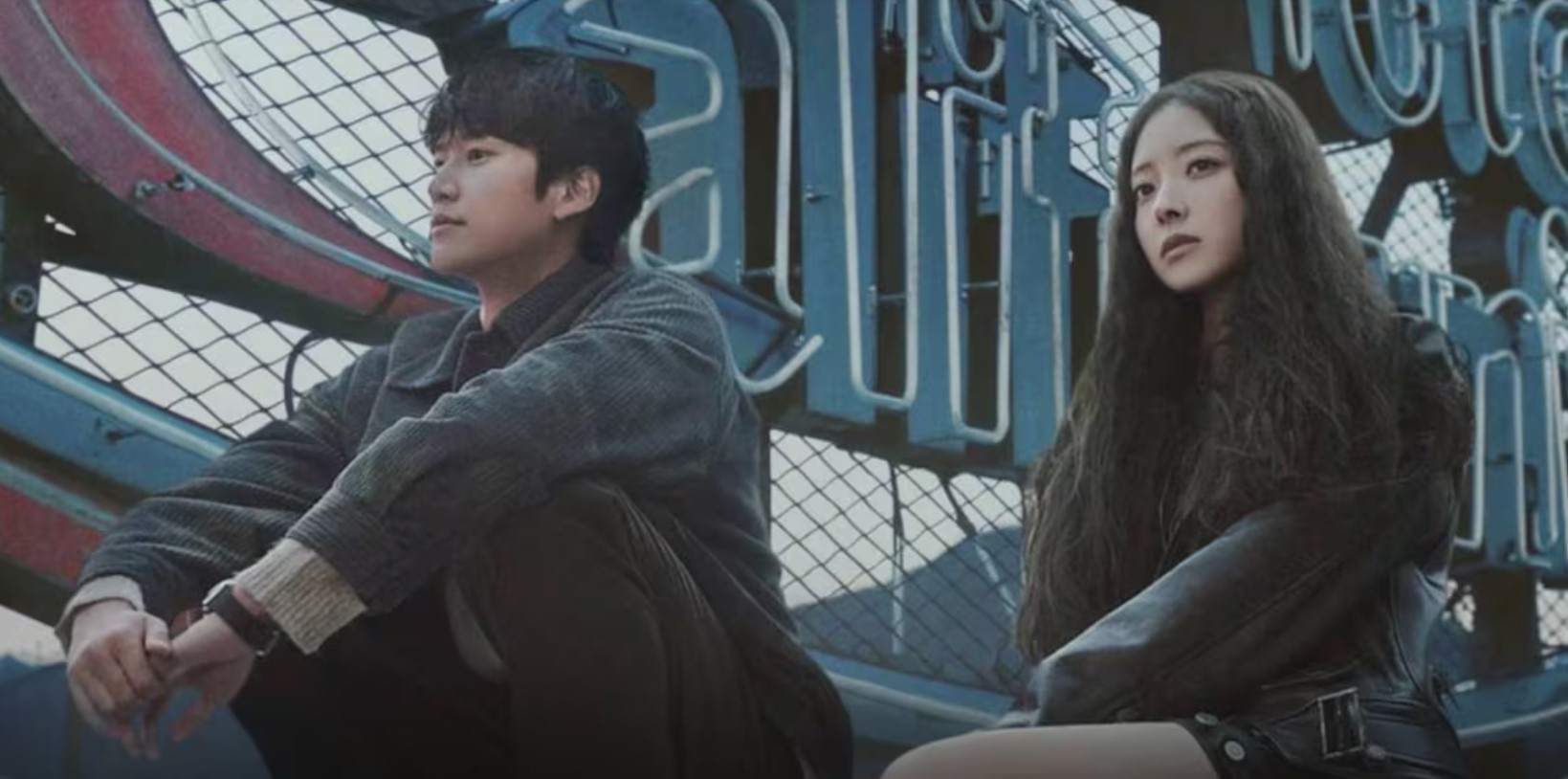 A moody and atmospheric scene from Motel California, showing the two main characters sitting side by side in front of a neon sign, reflecting on their thoughts in a moment of quiet connection.