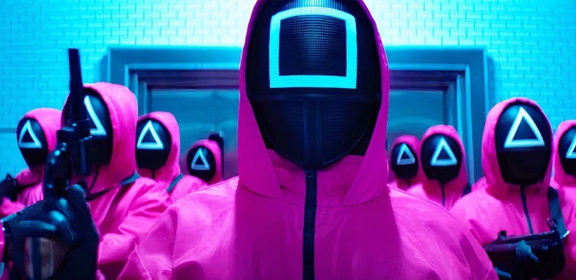 Squid Game Season 2 full review - ominous shot of masked guards in pink outfits, carrying weapons and standing in a dimly lit hallway, adding to the chilling atmosphere of the game.