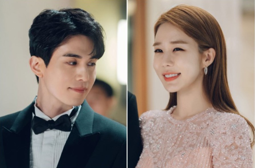 Main characters from the drama Touch Your Heart – the man in a tuxedo looking at the woman in a sparkling pink dress, both smiling.