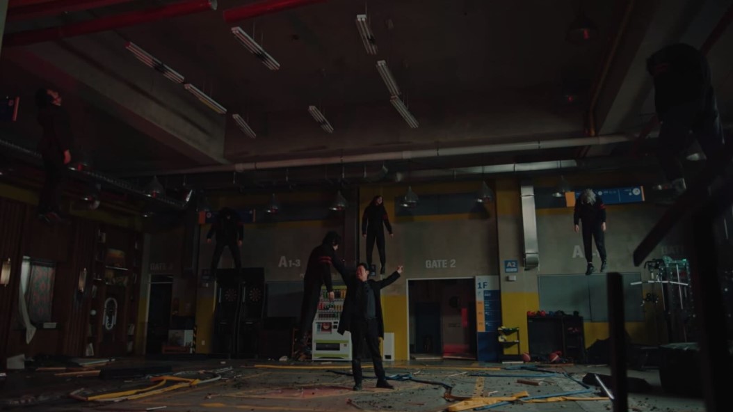 A man stands in a room, seemingly suspended in mid-air, creating a supernatural atmosphere.