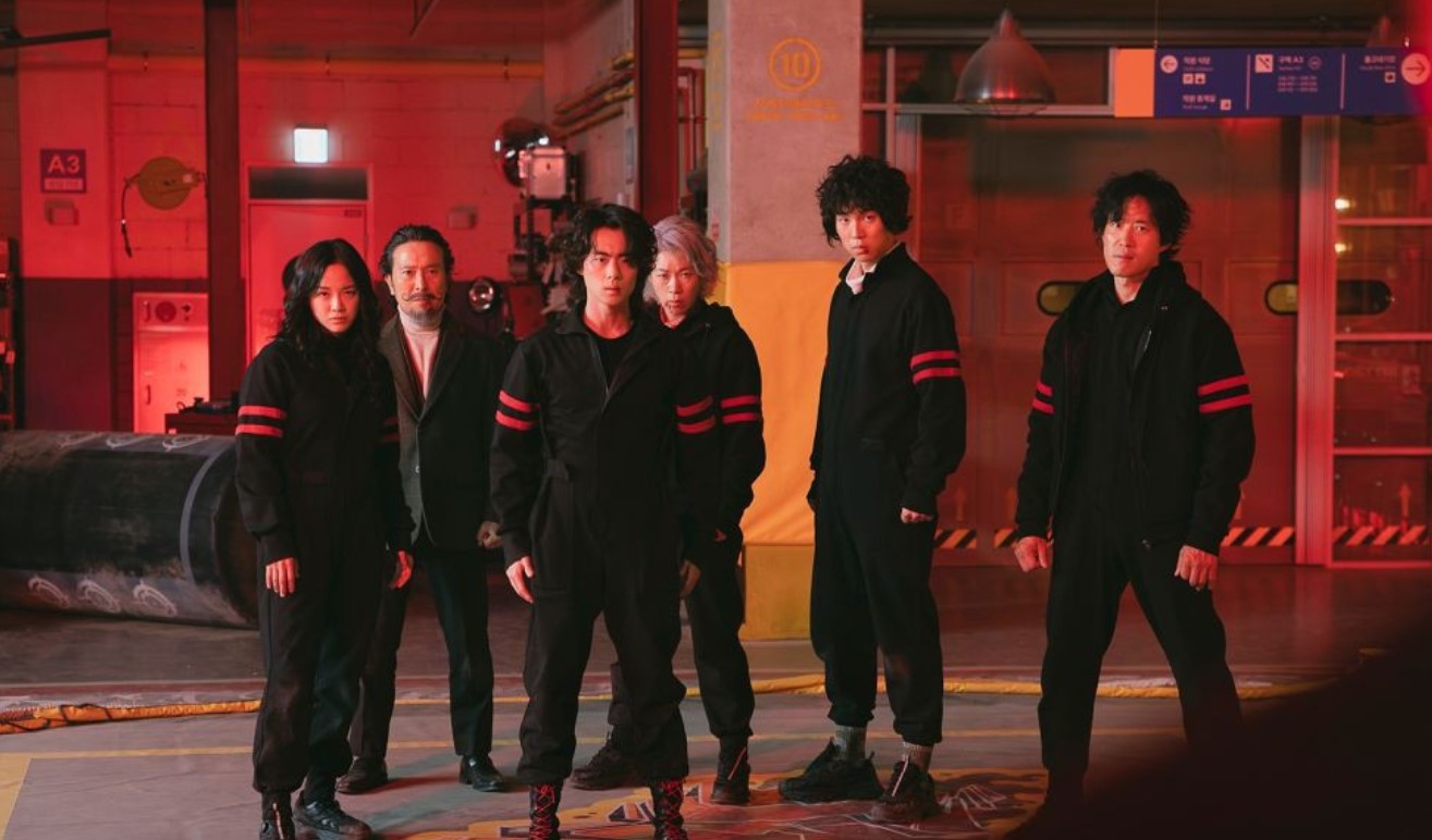 Several individuals gather in a warehouse setting, highlighting the atmosphere of Uncanny Counter Season 2.