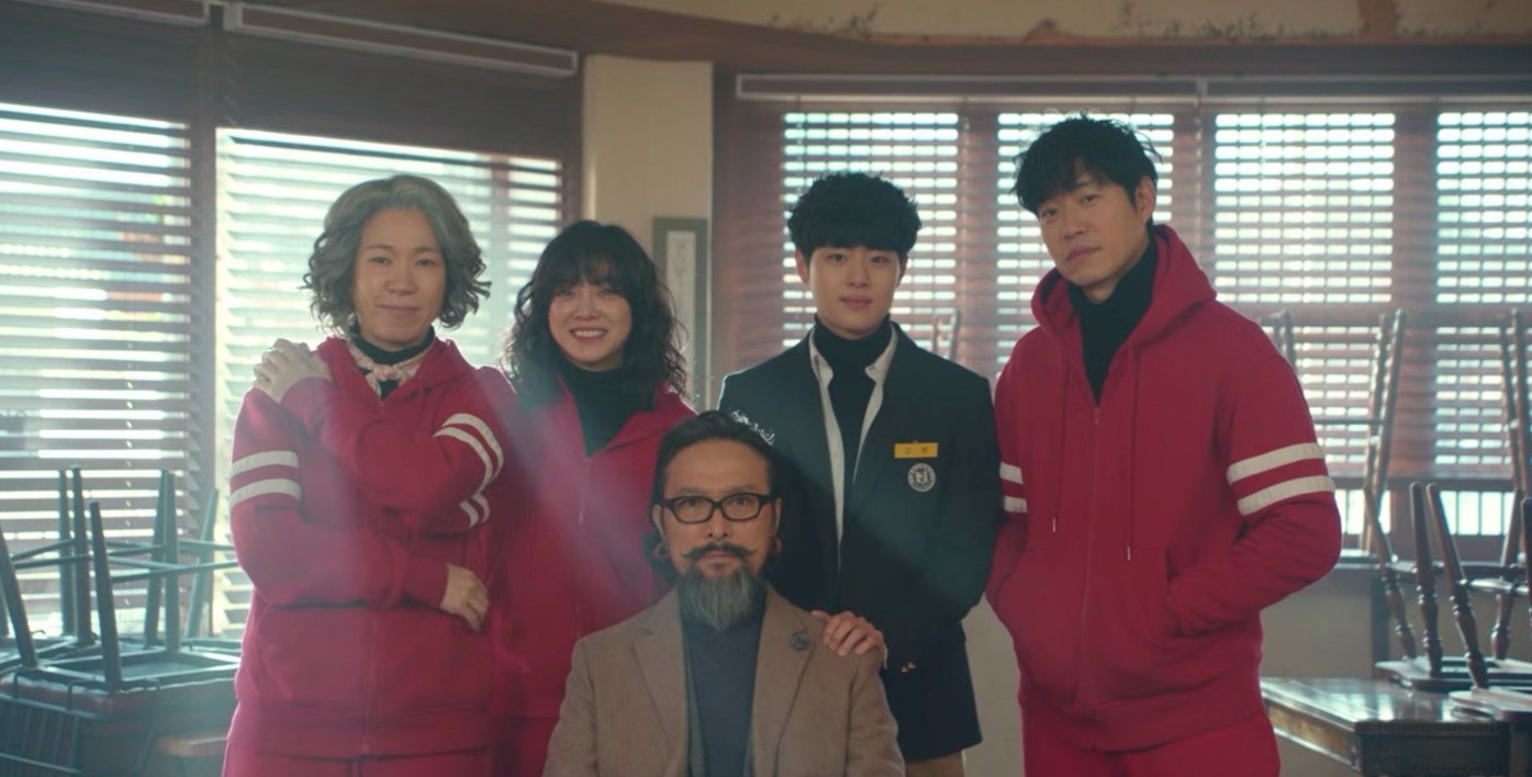 Several individuals in red jackets gathered together, representing characters from "The Uncanny Counter" Season 2.