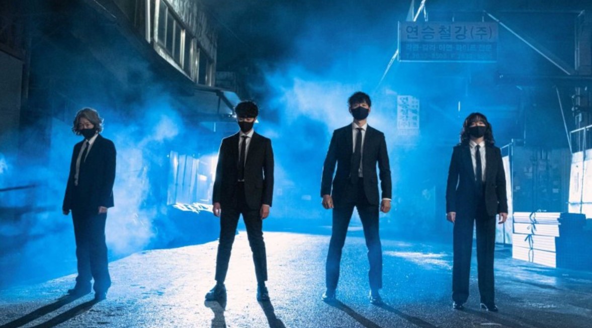 Main characters from Uncanny Counter Season 1 – a group of four individuals in black suits and masks, standing together in a misty alley, exuding a powerful, determined look. Uncanny Counter Season 1 full review.