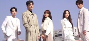 Main cast of Doom at Your Service standing together in fashionable white and beige outfits with a city backdrop