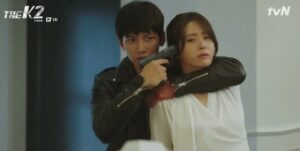 Intense scene from The K2: Kim Je Ha (Ji Chang Wook) holds a gun to Choi Yoo Jin (Song Yoon Ah), showcasing the high-stakes action and tension in the series.