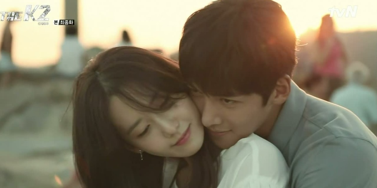 Kim Je Ha (Ji Chang Wook) embraces Go An Na (Im Yoon Ah) in a romantic beachside moment from The K2, capturing the warmth and connection between the characters.