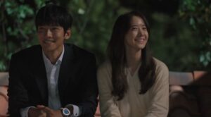 Kim Je Ha (Ji Chang Wook) and Go An Na (Im Yoon Ah) share a joyful moment together, smiling and sitting side by side in a heartwarming scene from The K2.