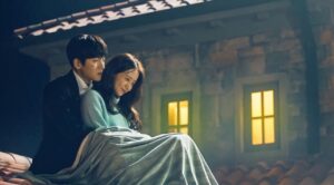 Romantic scene from The K2: Kim Je Ha (Ji Chang Wook) and Go An Na (Im Yoon Ah) share a quiet, intimate moment on a rooftop, wrapped in a blanket, highlighting their emotional connection.