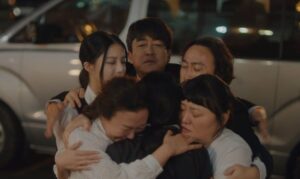 A heartfelt group hug from the K-drama "Drinking Solo", where the characters share an emotional moment of support and connection, expressing deep feelings in a touching scene.