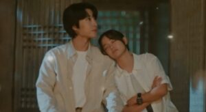 A tender moment from the K-drama "Drinking Solo", featuring the two main characters sharing a peaceful and intimate moment, with the female lead resting her head on the male lead's shoulder.