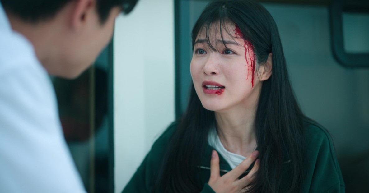 Distressed female character from 'Revenge of Others' with blood on her face and mouth, as she confronts another character, showing signs of injury and intense emotion.