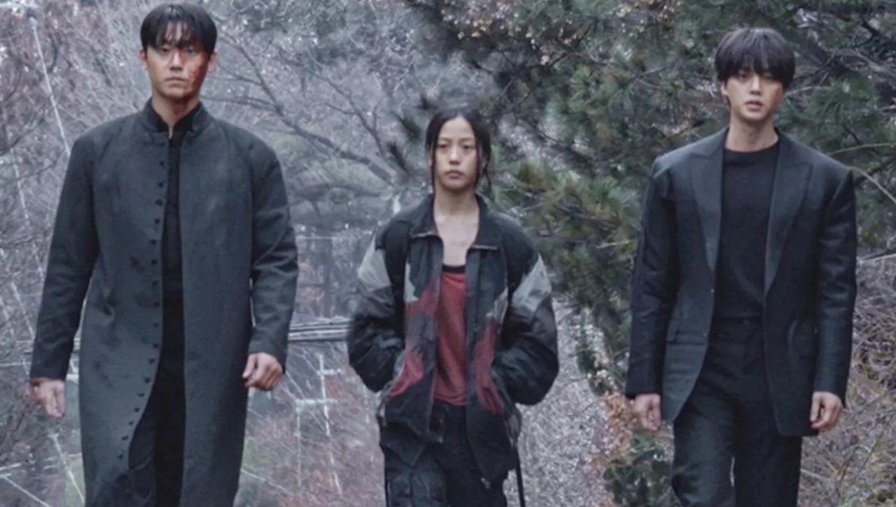 Main characters from Sweet Home Season 2 walking together in a dystopian environment, dressed in post-apocalyptic outfits, with a misty forest backdrop.