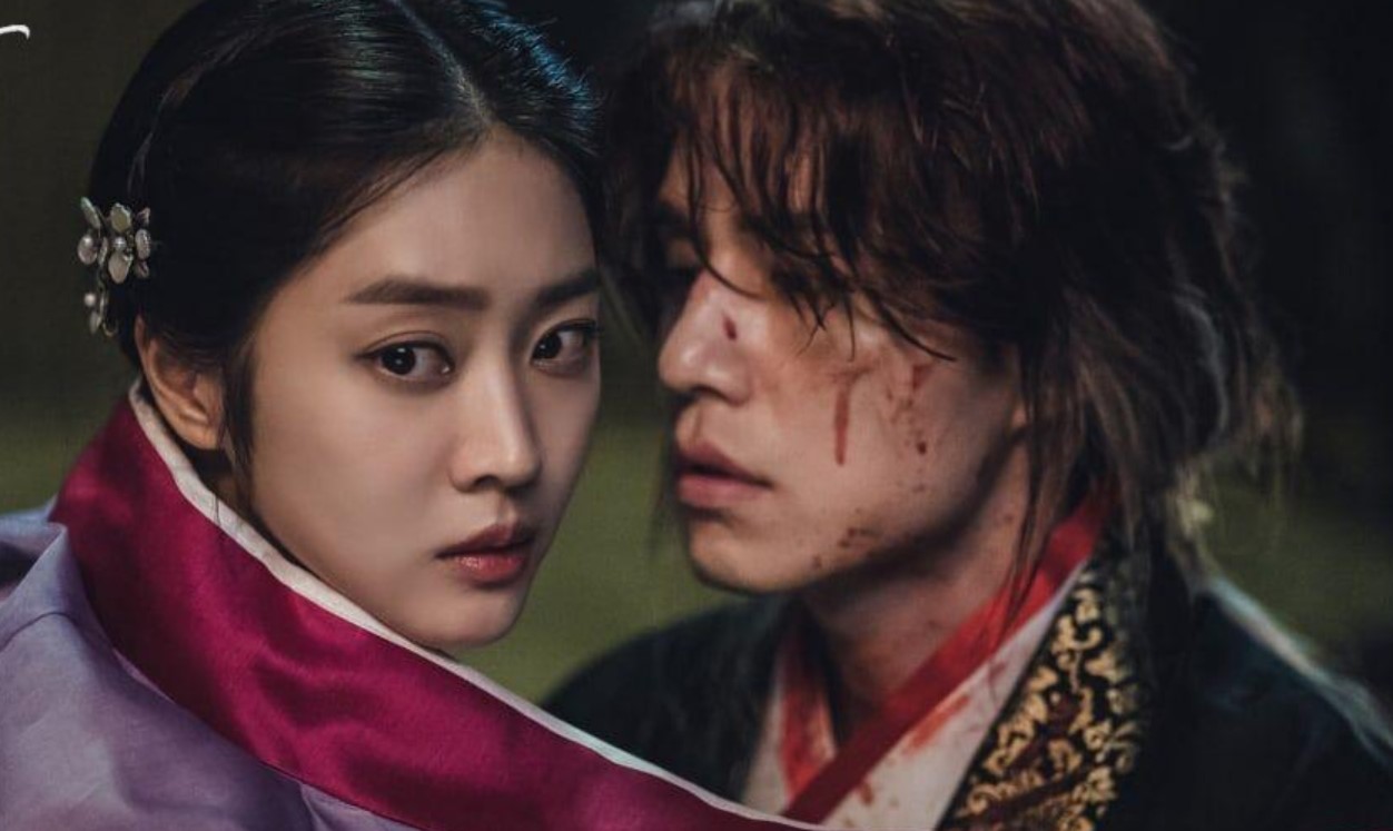 Emotional scene from 'Tale of the Nine-Tailed,' showing Jo Bo-ah and Lee Dong-wook in a close, dramatic moment, with Lee Dong-wook's character injured and bloodied.