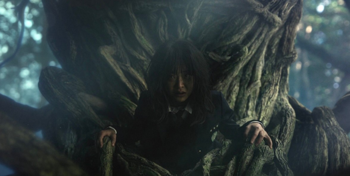 Woman trapped in eerie forest tree roots, dark mysterious atmosphere