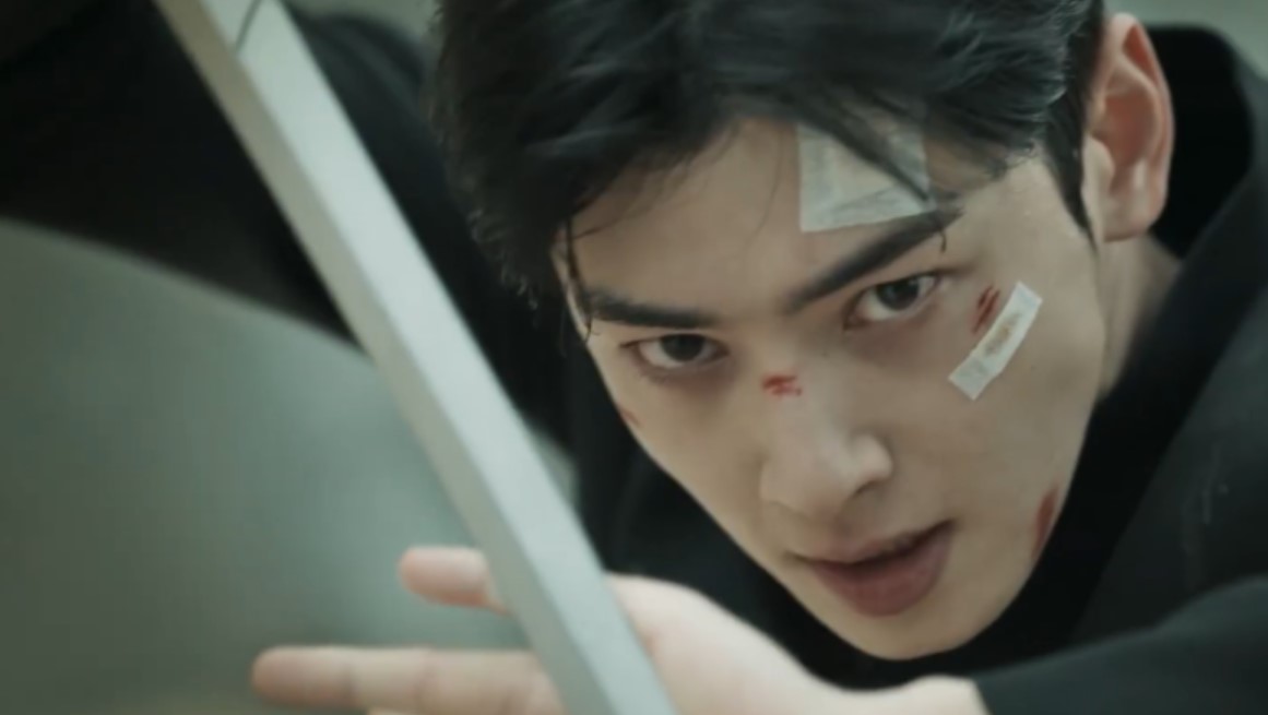 Character from the 'Island' drama series with battle scars, intensely staring while reaching forward, showcasing a moment of determination and struggle.
