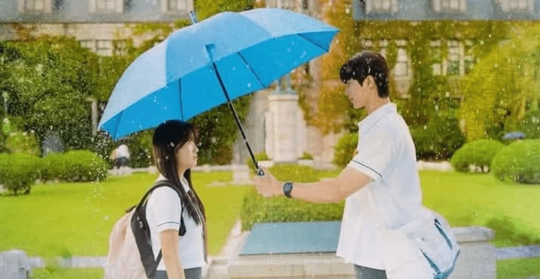 A man and woman hold an umbrella together in the rain, reflecting the drama "Lovely Runner" and its Most-Streamed KDrama Soundtracks.