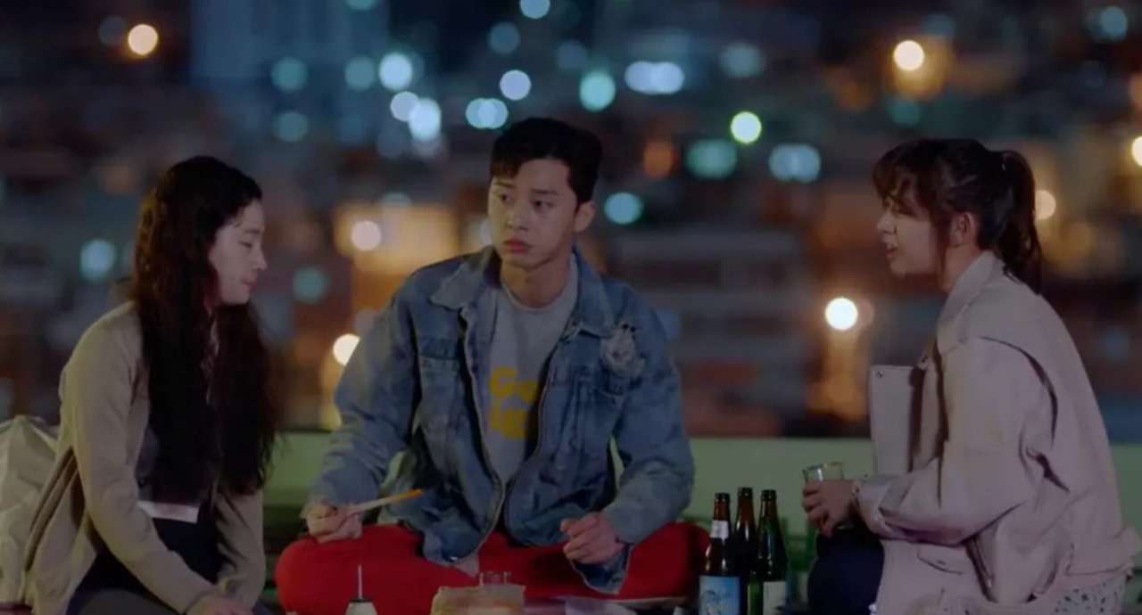 Scene from Fight for My Way showing Park Seo-joon sitting between Kim Ji-won and Ahn Jae-hong on a rooftop at night, sharing a casual moment with drinks and food, highlighting their strong friendship and the show's heartfelt dynamics.