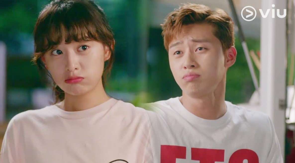 Park Seo-joon and Kim Ji-won from Fight for My Way making cute, pouty faces while dressed in casual T-shirts, showcasing their playful and endearing chemistry in a light-hearted scene from the drama.