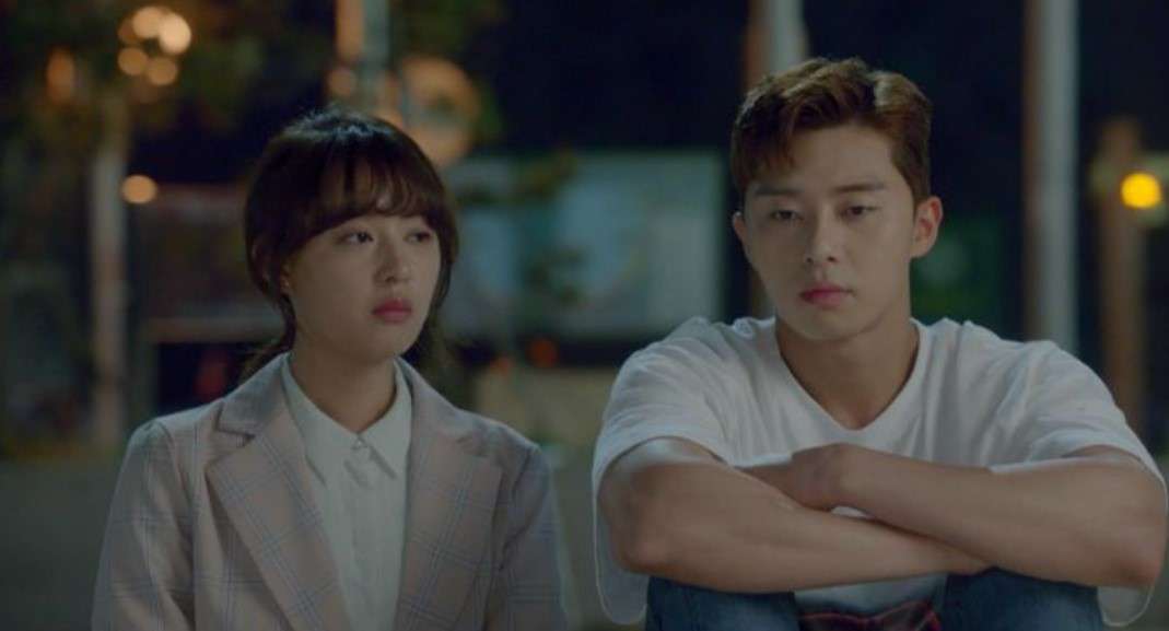 Park Seo-joon and Kim Ji-won in a heartfelt scene from Fight for My Way, sitting side by side in a quiet moment. Both characters look contemplative, reflecting the emotional depth and complexity of their relationship in the drama.