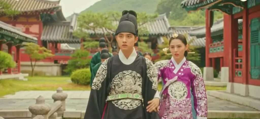 Royal palace scene from Korean drama 100 Days My Prince showing the Crown Prince in black ceremonial robes and the Crown Princess in an elegant purple hanbok, walking through the palace courtyard 