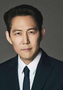 Lee Jung-jae in a formal suit and tie, showcasing a professional look from his Lee Jung-jae profile and biography.