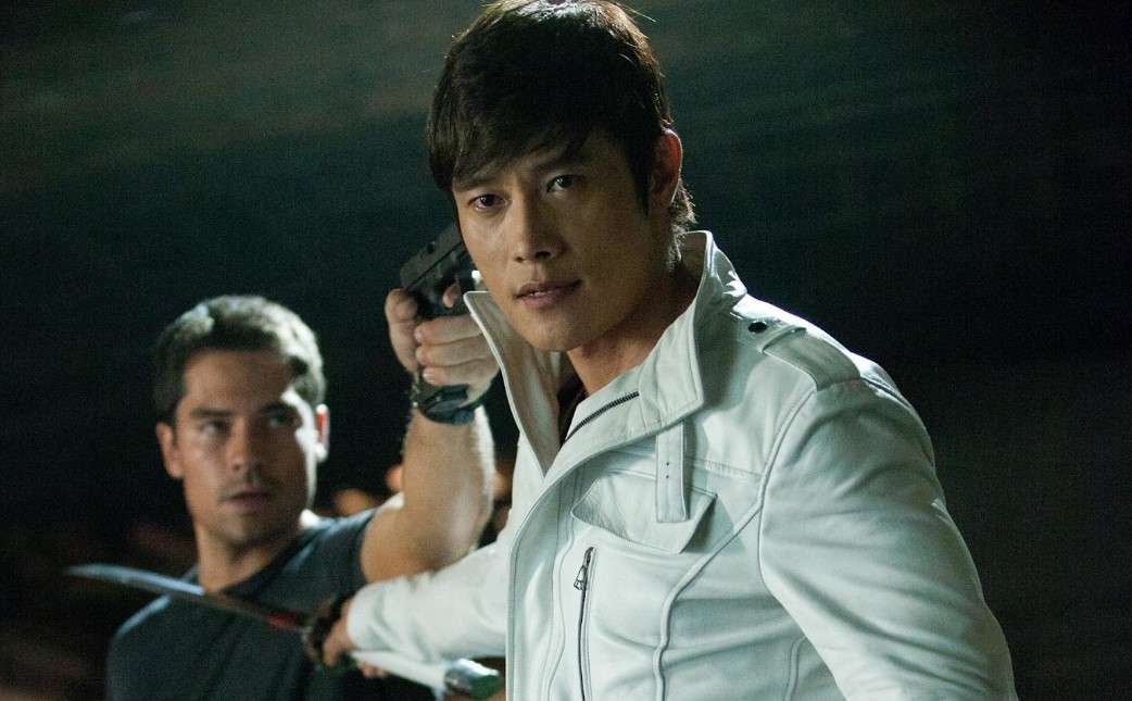 A portrait of Lee Byung-hun in a white jacket, gripping a knife, reflecting his dynamic persona. 