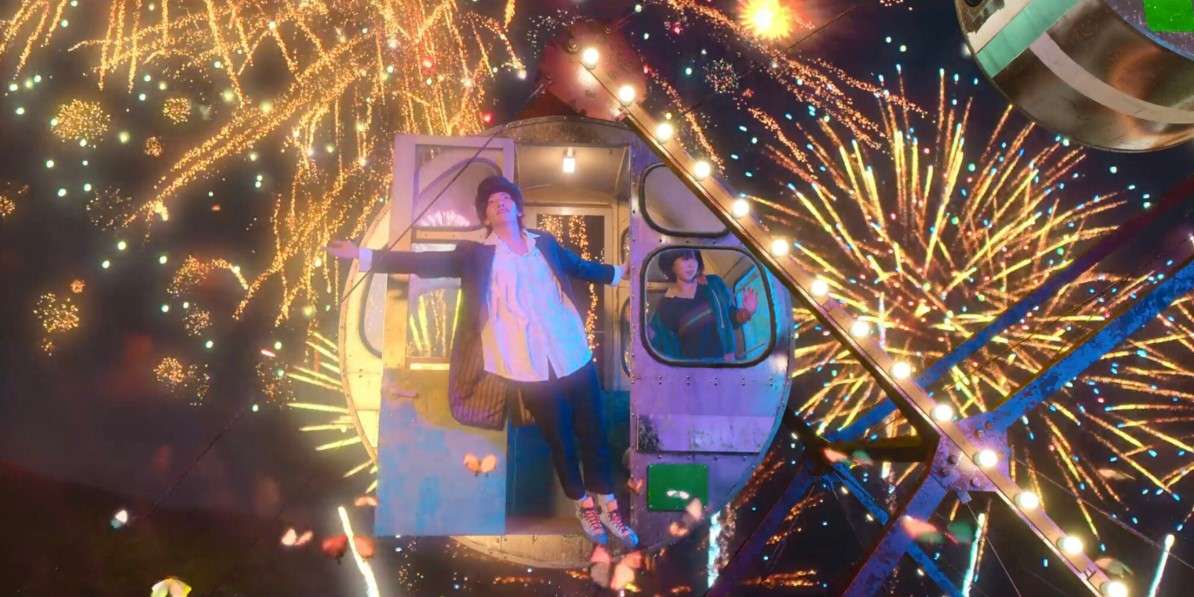 Scene from "The Sound of Magic" with characters in a Ferris wheel cabin surrounded by vibrant fireworks and butterflies, creating a magical night atmosphere.