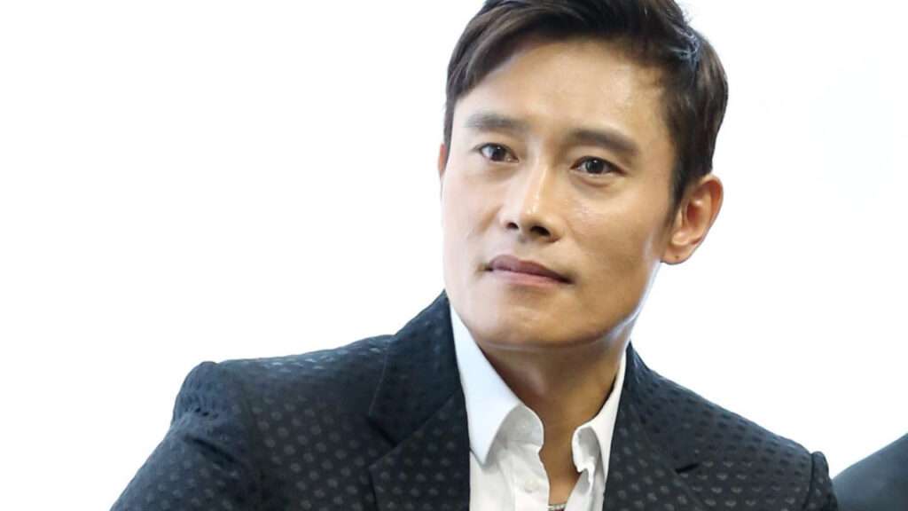 Professional portrait of Lee Byung-hun, showcasing the star of Korean drama and cinema in a stylish black suit, highlighting his Lee Byung-hun profile and biography.