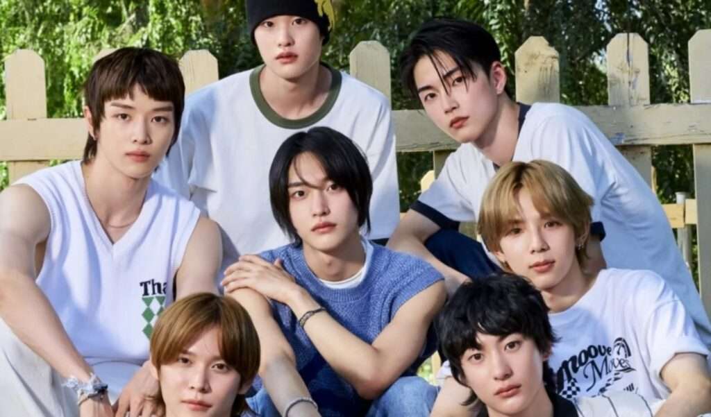 RIIZE K-pop group members Shotaro, Eunseok, Sungchan, Wonbin, Sohee, and Anton posing casually outdoors against a wooden fence with lush greenery, embodying the fresh energy of Hallyu trends in 2025.