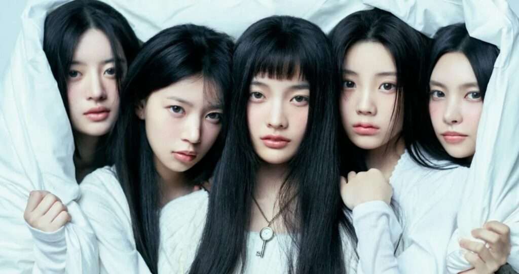 ILLIT K-pop group members posing together under a white sheet with a dreamy aesthetic, showcasing their unique style and contributing to the Hallyu trend in 2025