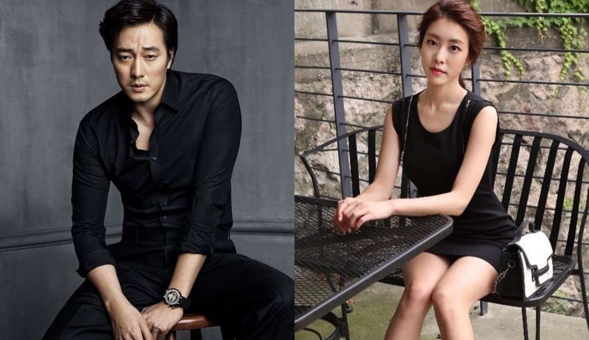 So Ji Sub in a black outfit sitting thoughtfully, alongside his wife Jo Eun-jung in a black dress at a table, reflecting their personal life from So Ji Sub profile and biography.
