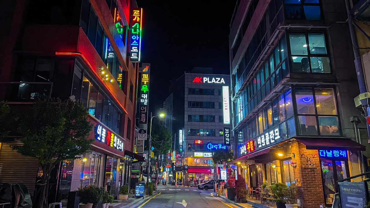 Night view of vibrant Hongdae Seoul streets near AK Plaza, location of BTS J-Hope 'AND WHAT?' solo exhibition