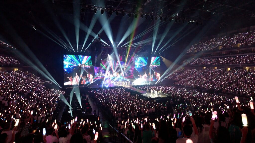 K-pop world tour 2026 concert with massive crowd and lightsticks ocean