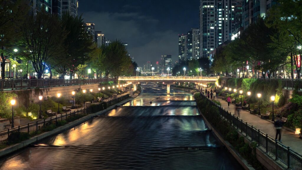 Serene night view of Cheonggyecheon Stream in Seoul with illuminated walkways.