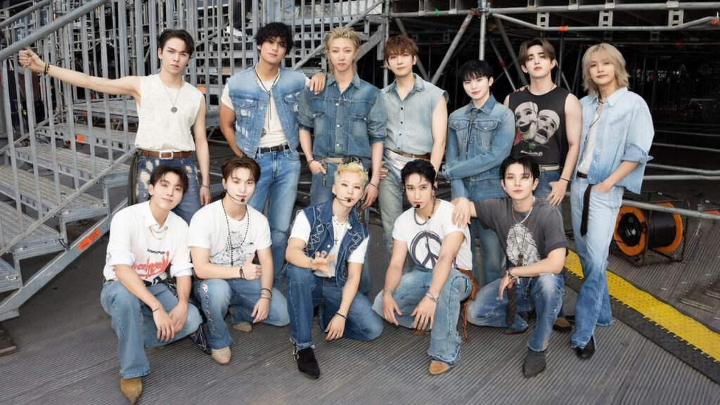 Energetic group of SEVENTEEN members performing on a vibrant K-pop stage