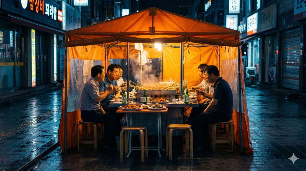 Glowing traditional Korean pojangmacha street food tent on a rainy summer night in Seoul with warm light steam and soju bottles inside